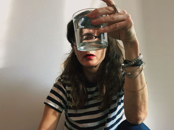 Portrait of young woman drinking water