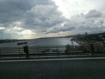 Bridge over road against sky in city