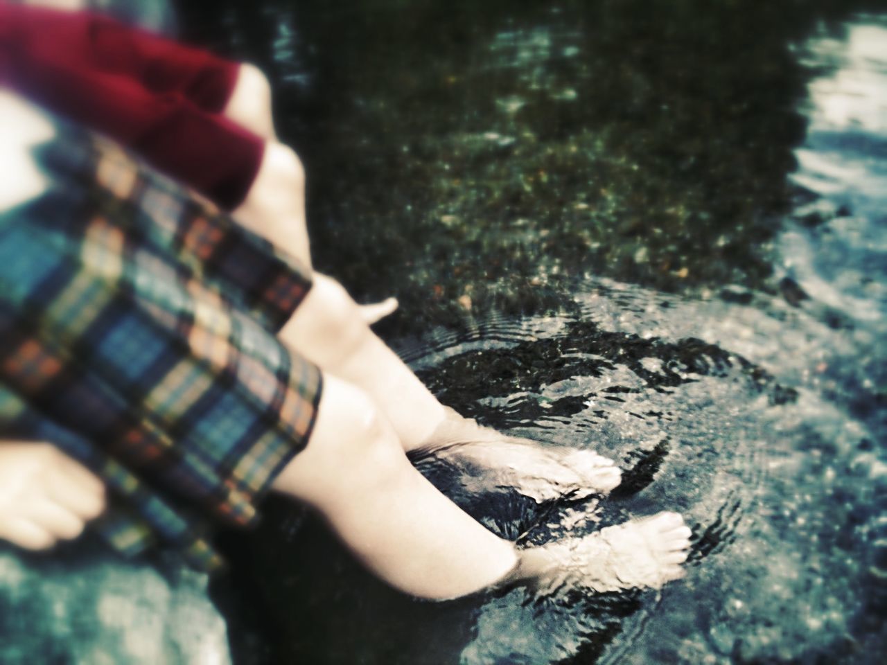 lifestyles, water, person, leisure activity, holding, part of, focus on foreground, lake, cropped, human finger, outdoors, unrecognizable person, day, reflection, nature, low section