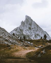 Low angle view of rocky mountain against sky