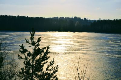 Scenic view of lake against sky at sunset