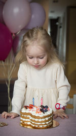 Portrait of smiling girl playing with toys at home