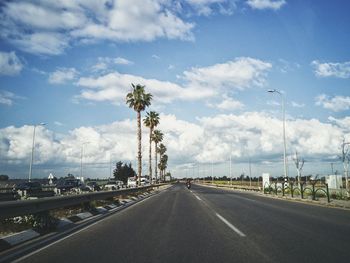 Road by city against sky