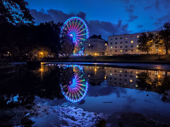 View of illuminated ferris wheel at night
