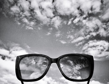 Close-up of sunglasses against sky