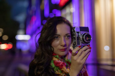 Beautiful woman photographing outdoors