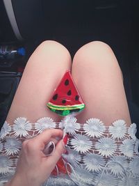 Midsection of woman holding watermelon candy