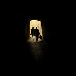 Silhouette people in tunnel