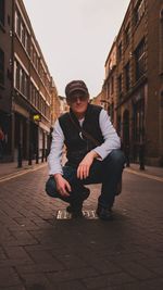 Full length portrait of young man in city