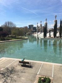 High angle view of swimming pool by lake against sky