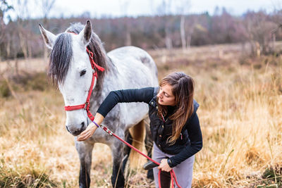 Side view of horse standing on field