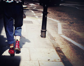 Woman standing on footpath