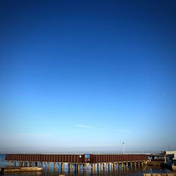 Low angle view of street against clear blue sky