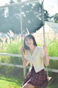 Young woman swinging at playground