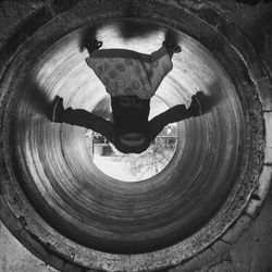 Upside down image of man in pipe