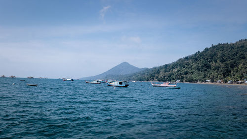 Boats in sea against sky