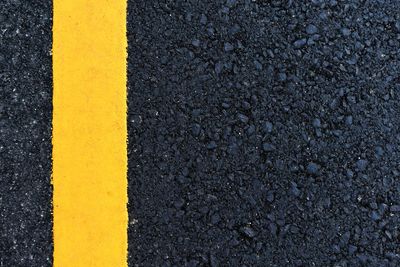 High angle view of yellow sign on road