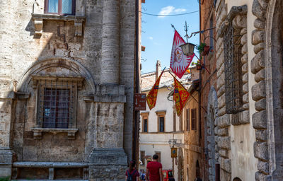 Low angle view of flags on old building