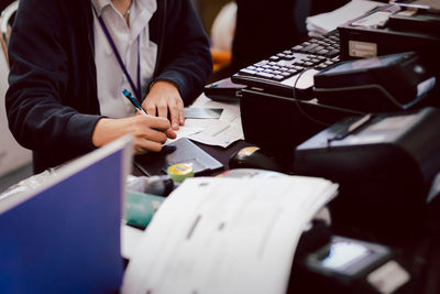 Midsection of business colleagues working at table