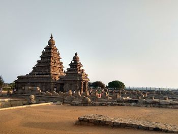 View of old building against clear sky sea shore temple