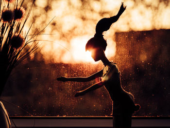 Midsection of woman holding umbrella while standing outdoors