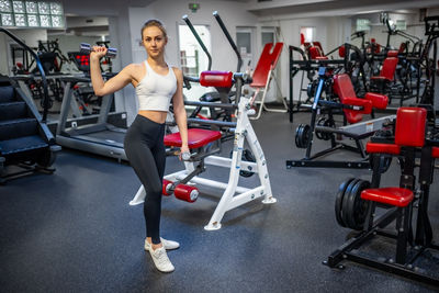 Low section of woman exercising in gym