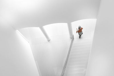 High angle view of woman by steps in building