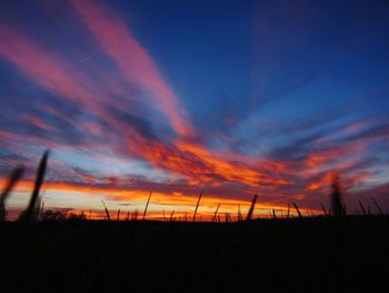 Silhouette landscape against sky at sunset