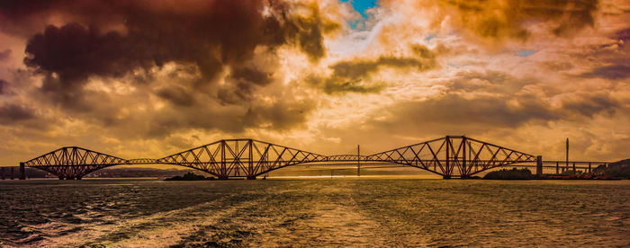 View of bridge over sea against cloudy sky