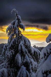 Scenic view of snow against sky during sunset