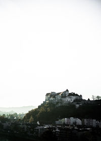 Buildings in town against clear sky