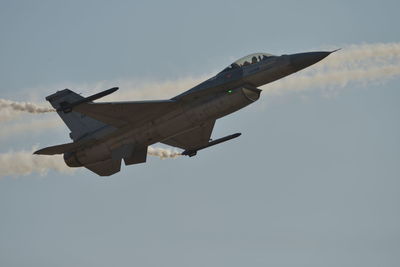 Low angle view of airplane flying against sky