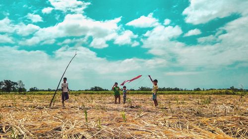 People on field against sky