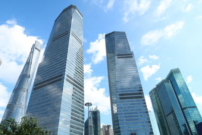 Low angle view of modern buildings in city against sky