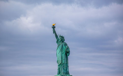 Low angle view of statue against cloudy sky