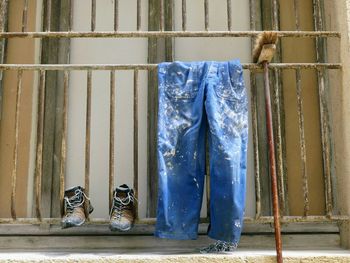 Close-up of shoes hanging on metal wall