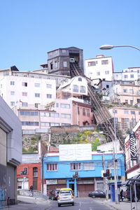 View of residential buildings against clear blue sky