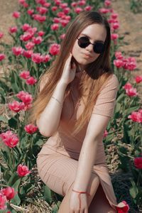 High angle view of woman relaxing on pink flowering plants