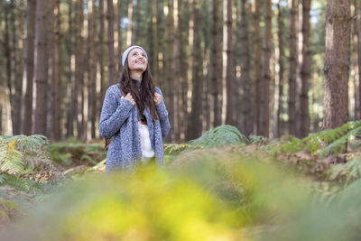 Smiling young woman in forest