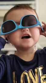 Close-up portrait of cute boy wearing sunglasses