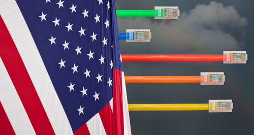 Digital composite image of cable with american flag against sky