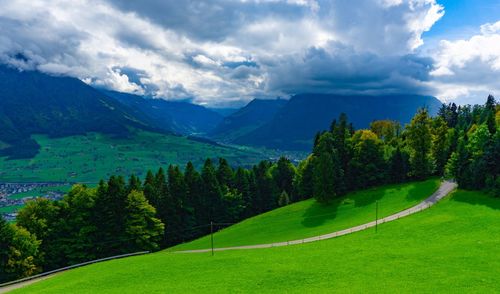 Scenic view of green mountains against sky