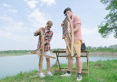 Rear view of couple standing on field