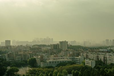 High angle view of buildings in city against sky