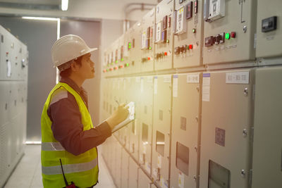 Portrait of woman standing in factory