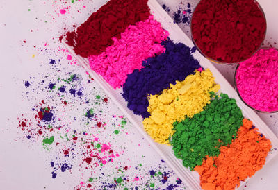 High angle view of multi colored candies on white background