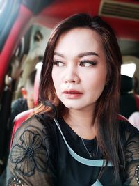 Portrait of beautiful young woman in car