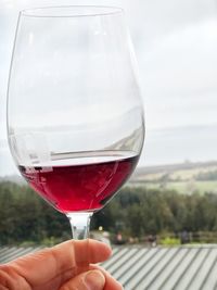 Close-up of hand holding glass of drink