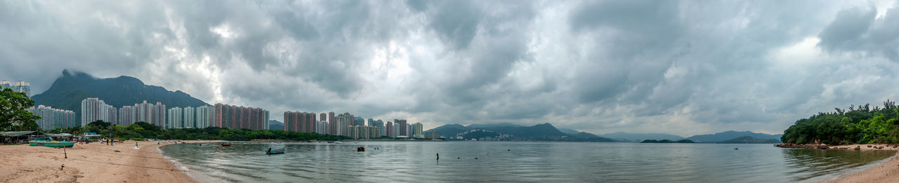 Panoramic view of sea and buildings against sky