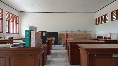 Empty chairs and tables in building